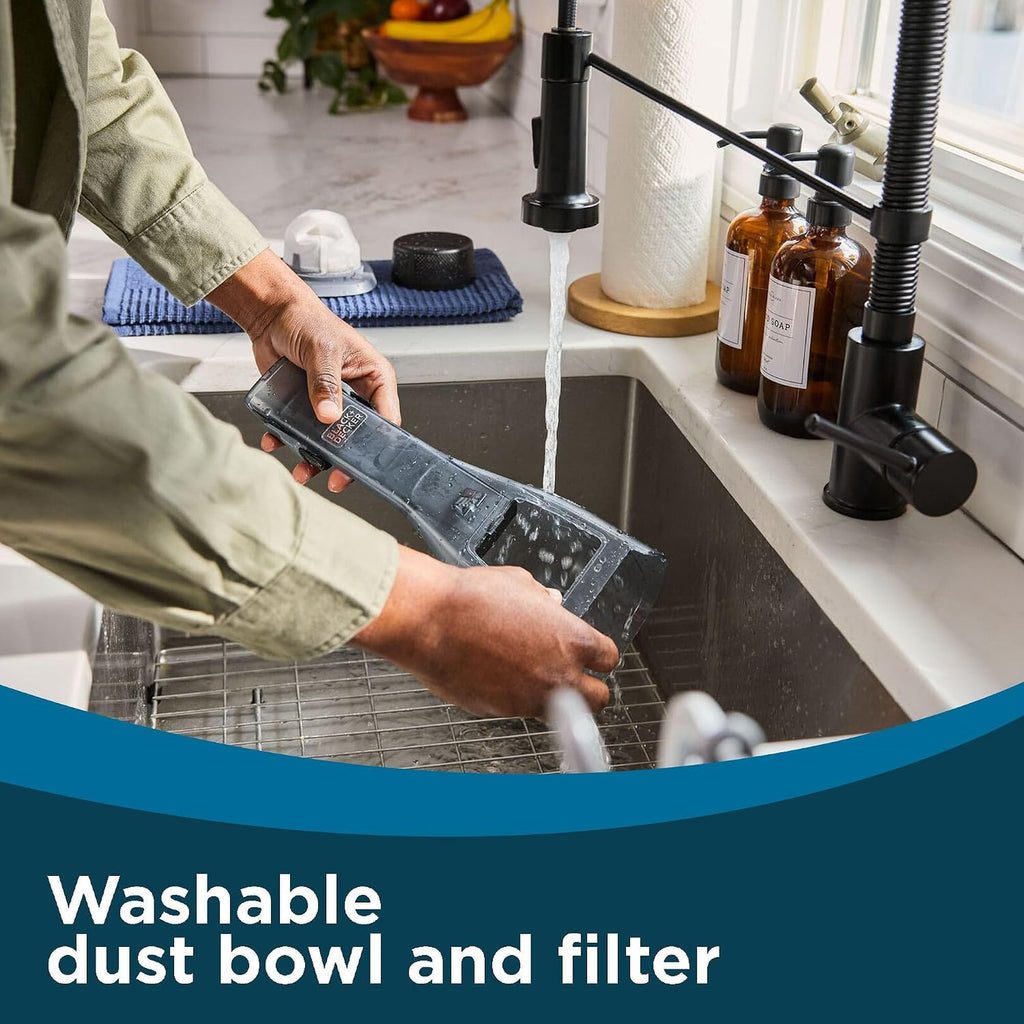 Rinsing the Dustbuster Reveal washable dust bowl and filter in a sink