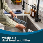 Rinsing the Dustbuster Reveal washable dust bowl and filter in a sink