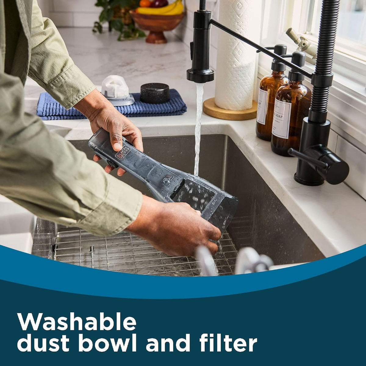 Rinsing the Dustbuster Reveal washable dust bowl and filter in a sink